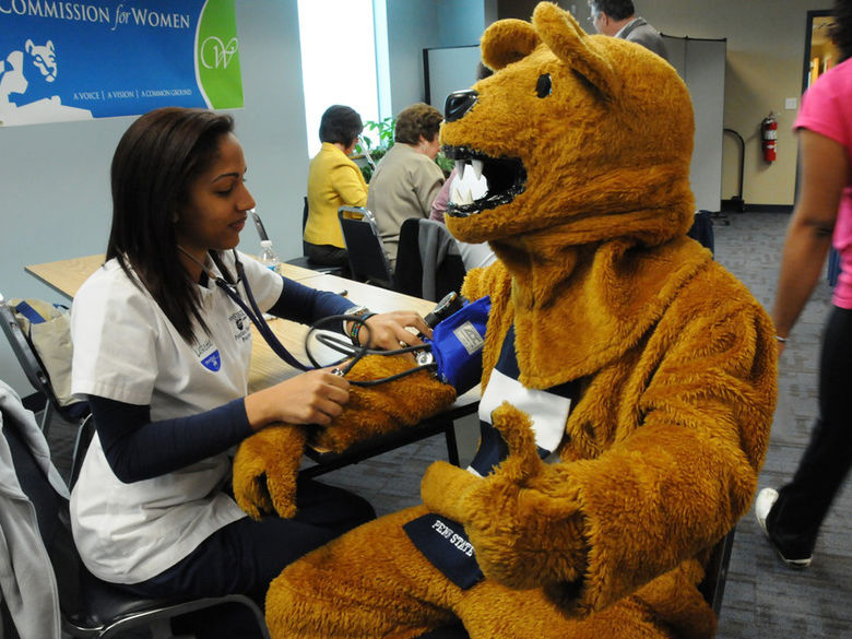 Nittany Lion visiting a nurse