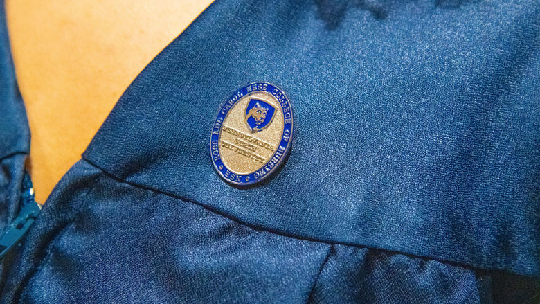A pin placed on a student's chest.