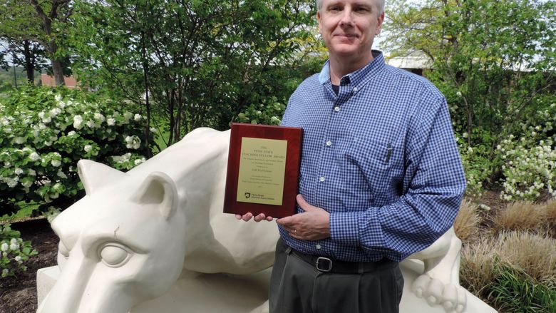 Gib Prettyman with Alumni/Student Award for Excellence in Teaching plaque
