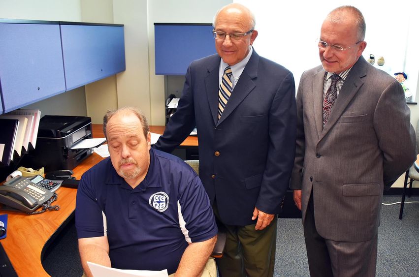 Pictured reviewing the contracts are, from left, CCPS Director Ted Mellors, Outreach and Continuing Education Director Joseph Segilia, and Chancellor and Chief Academic Officer Dr. Charles Patrick.