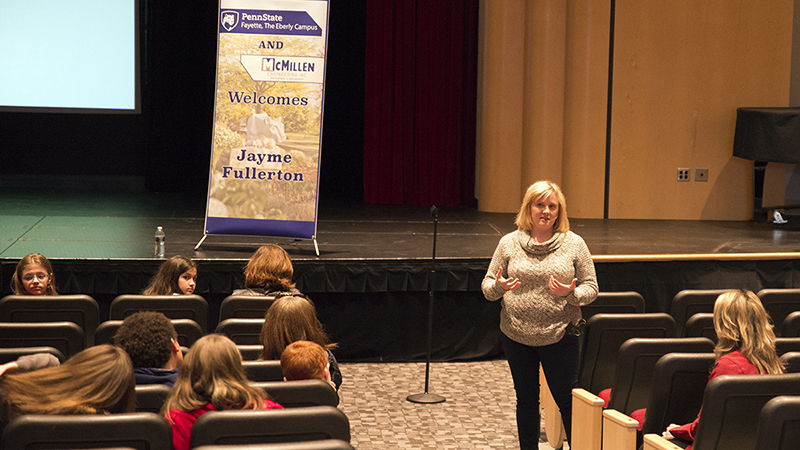 Jayme Fullerton answering questions from the audience. 