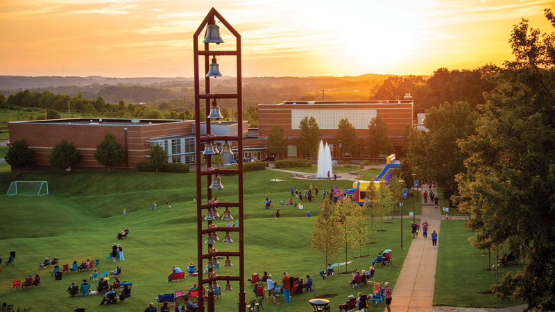 Sunset on campus with people walking around.