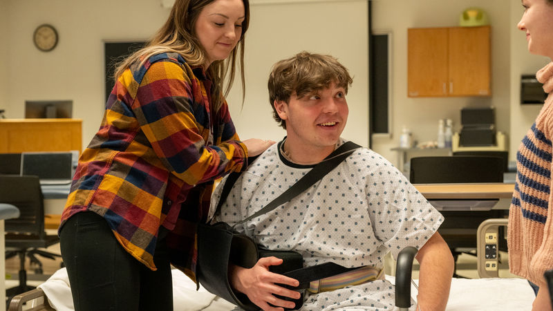 Seth Stewart performing as a patient in need during a Physical Therapist Assistant simulated care assignment.
