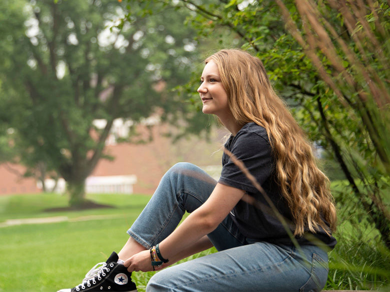A female student sitting on campus.