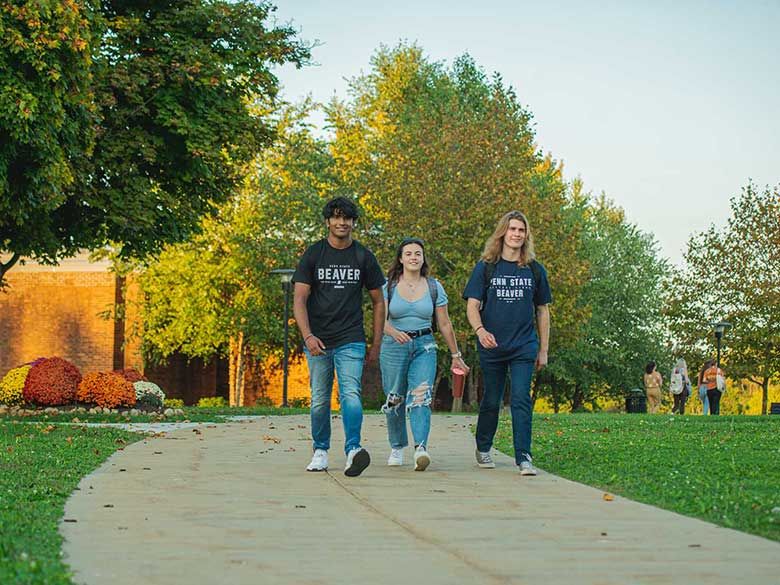 Three student walking on the Beaver campus. 