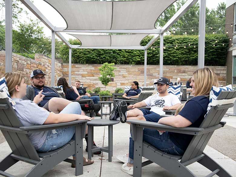 Students sitting in the new outdoor lounge area. 