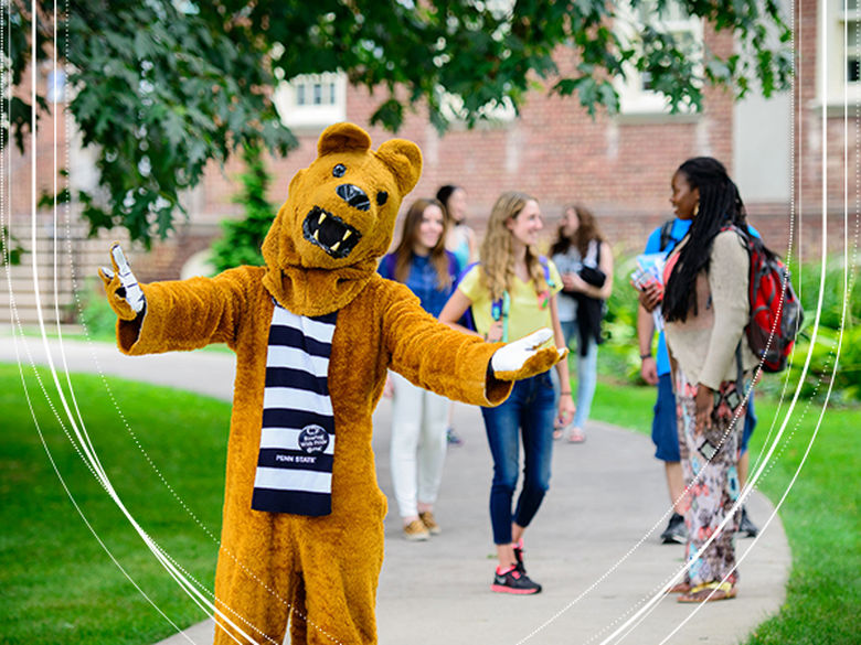 Lion mascot with students in the background.
