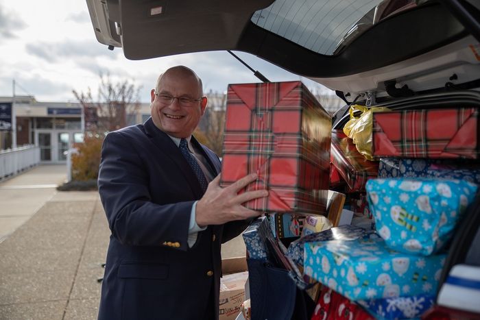 Man puts wrapped gift in car