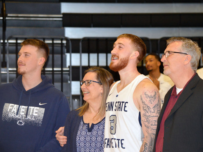 Boring standing alongside his family during Basketball Senior Day at Penn State Fayette.