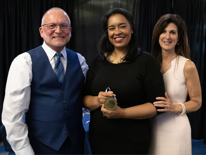 Award recipient Gina Marie Watts posing with Dr. Charles Patrick and Paula Congelo.