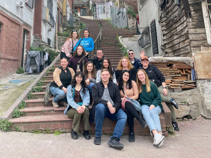 Penn State students gathering with faculty and guests for a photo on the streets of Istanbul.