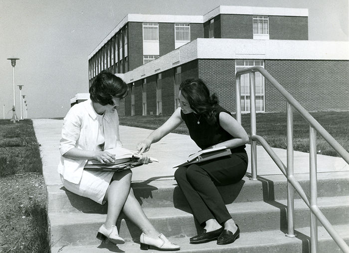 Two students in front of the Eberly Building