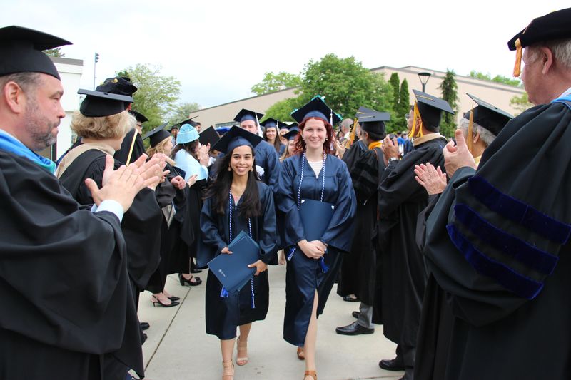 Humanities, Arts and Social Sciences (HASS) Student Marshal Adriana Perez Camacho (left) and Science Student Marshal Laura Post led their divisions out of the Beaver Community Center following the HASS and Science Commencement Ceremony on May 6, 2017.