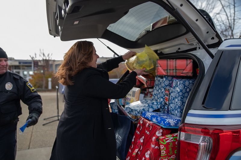 Woman places gifts in car Woman places gifts in car