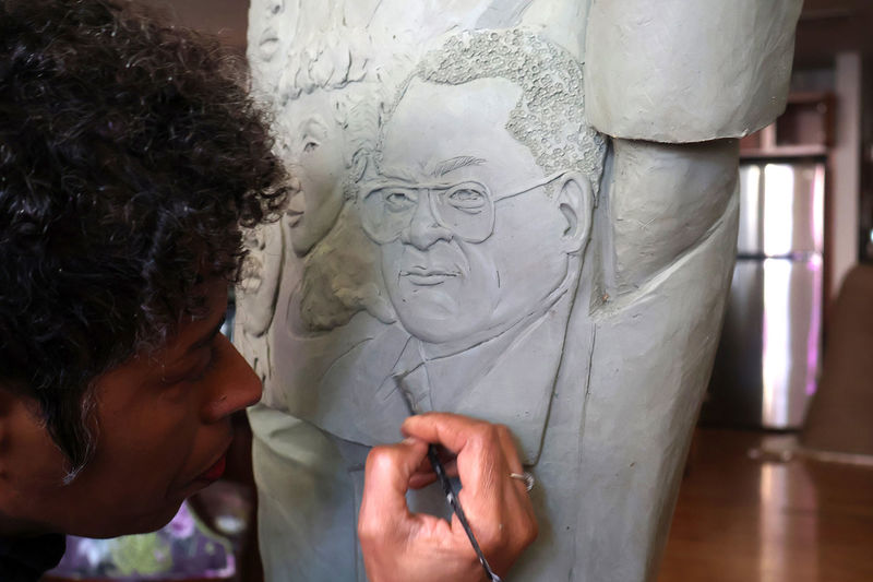 Vinnie Bagwell working on the coat of the Lawson Statute.