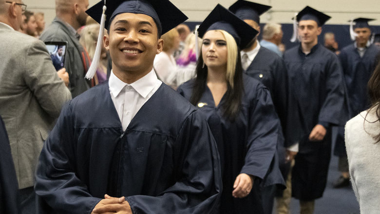 Marvin Sidon walking at commencement.