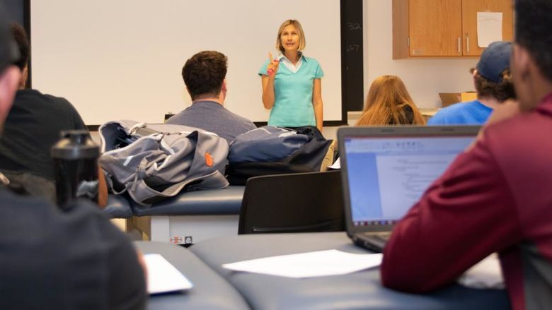 A Penn State professor giving a lecture to her students