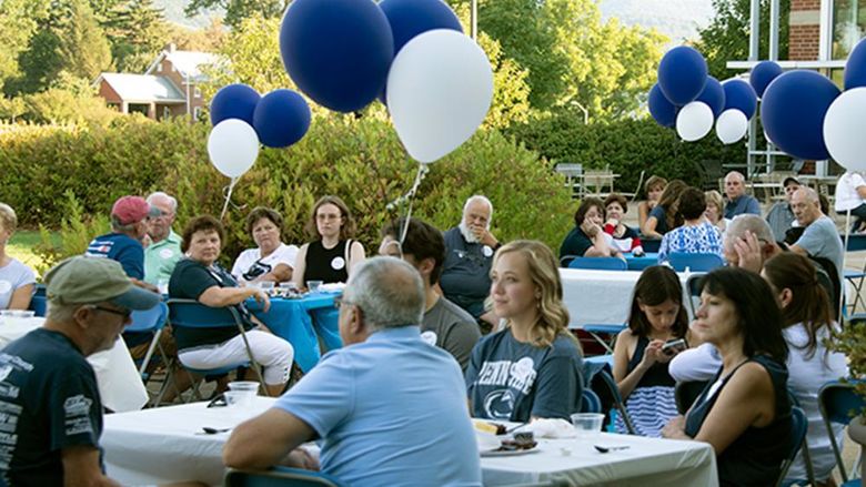 Penn State alumni and guests enjoying the barbecue at the Fayette Community Center. 