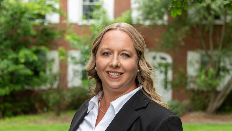 Lindsey-Simon Jones stands in front of the University House at Penn State Fayette, The Eberly Campus.