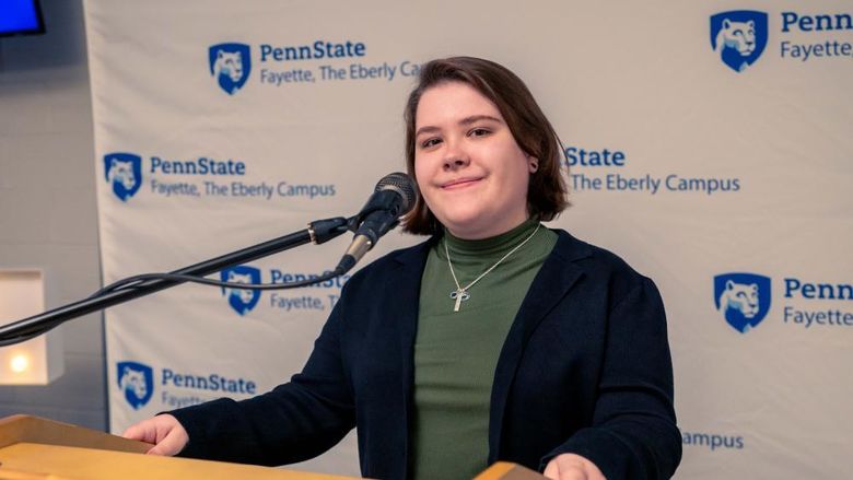 Skylar Wilson, a third-year psychology student at Penn State Fayette, The Eberly Campus, standing at the podium of the 15th annual Scholarship Donor Dinner. 