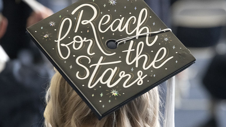 A graduate's cap reads "Reach for the stars"
