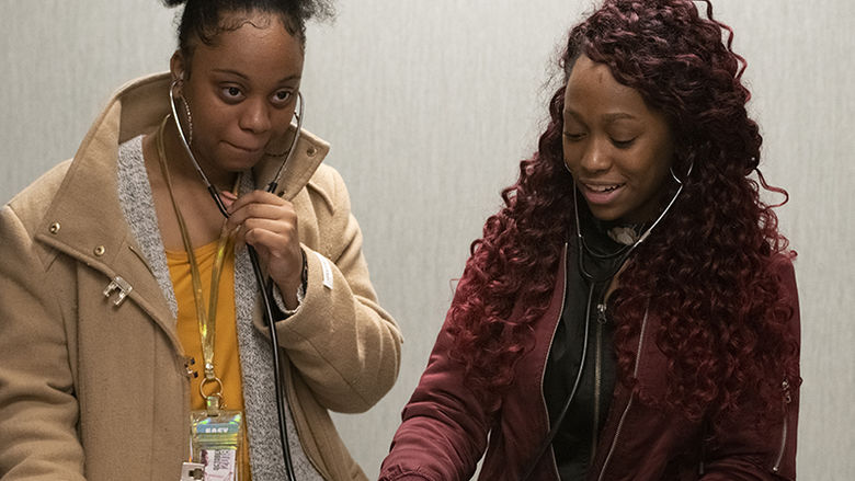 Caption 2: Laytara Burrel and Breonna Willias participate in a stethoscope demonstration.