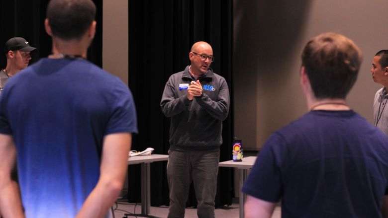 Penn State staff member Dan Murphy meets with his Pride Group during the Summer Leadership Conference