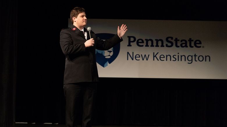 Man speaks on stage