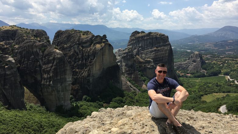 Aris Karagiorgakis, assistant teaching professor of psychology, at Meteora, a set of 13th c. Eastern Orthodox monasteries outside of Athens, Greece. His Summer 2020 class will visit the UNESCO World Heritage site.