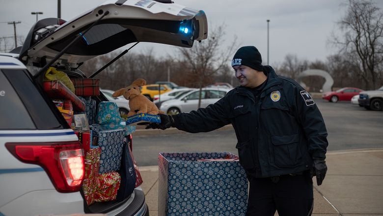 Police officer places gift in car
