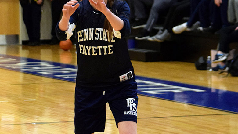 Student shooting a basketball.
