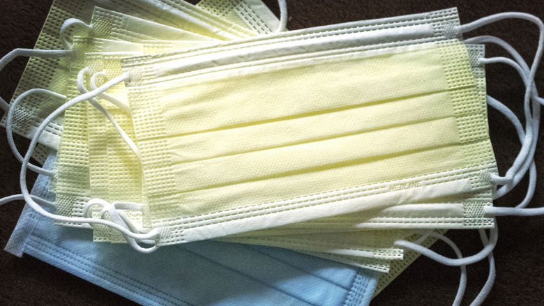 A stack of blue and yellow face masks. 