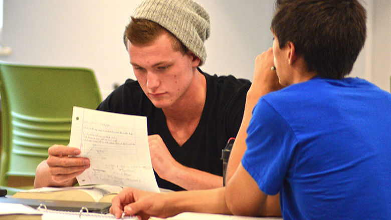 Two students studying in the student center.