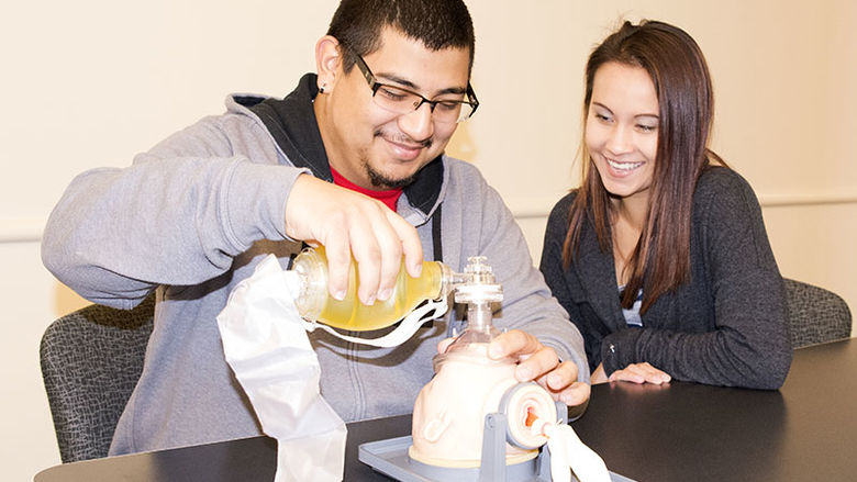 Two students using a CPR-AED Training Manikin.