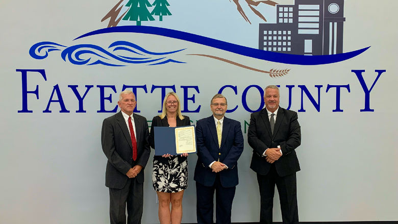 From left: Fayette County Commissioner and Secretary Dave Lohr, Penn State Fayette Mental Health Counselor Amanda Collins, Fayette County Commissioner and Vice Chairman Vince Vicites, and Fayette County Commissioner and Chairman Scott Dunn stand together after signing a proclamation recognizing September as Suicide Prevention and Awareness Month.