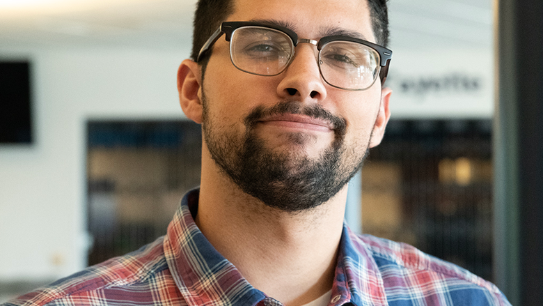 J. Ryan Simon, marketing communications specialist, smiling at the camera.