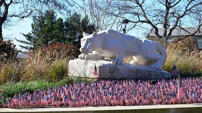 Lion statue surrounded by American Flags.