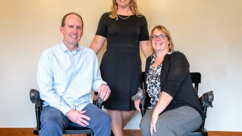 Lindsey Simon-Jones standing in between Kevin Maxwell and Nicole Hill.