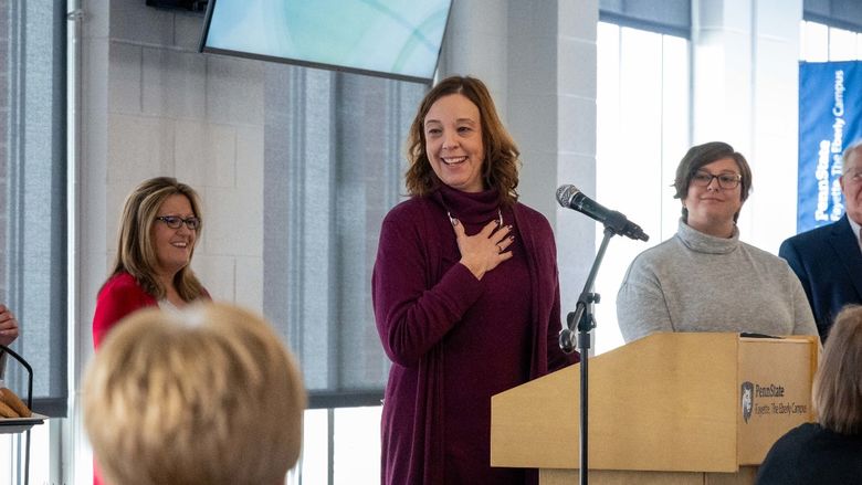 Alison Hawk speaks at the podium after receiving her Faculty Excellence in Teaching Award.