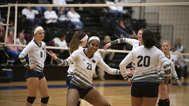 Women's volleyball players on the court.