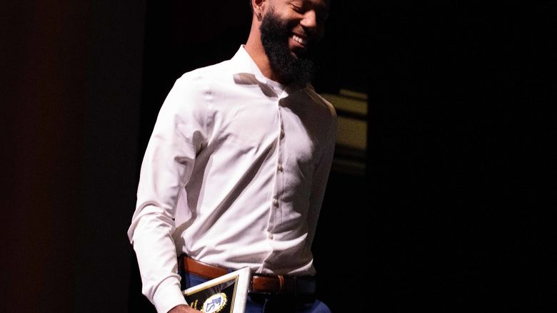 Dasilas Jones smiles while walking off stage after receiving the All-Time Leading Scorer award for Men’s Basketball at Penn State Fayette.