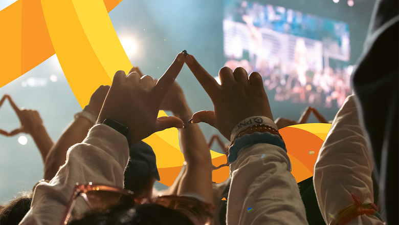 A student making the Four Diamonds symbol with her hands.