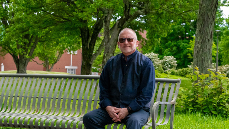 W. Charles Patrick sitting on campus.