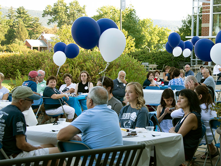 Penn State alumni and guests enjoying the barbecue at the Fayette Community Center. 