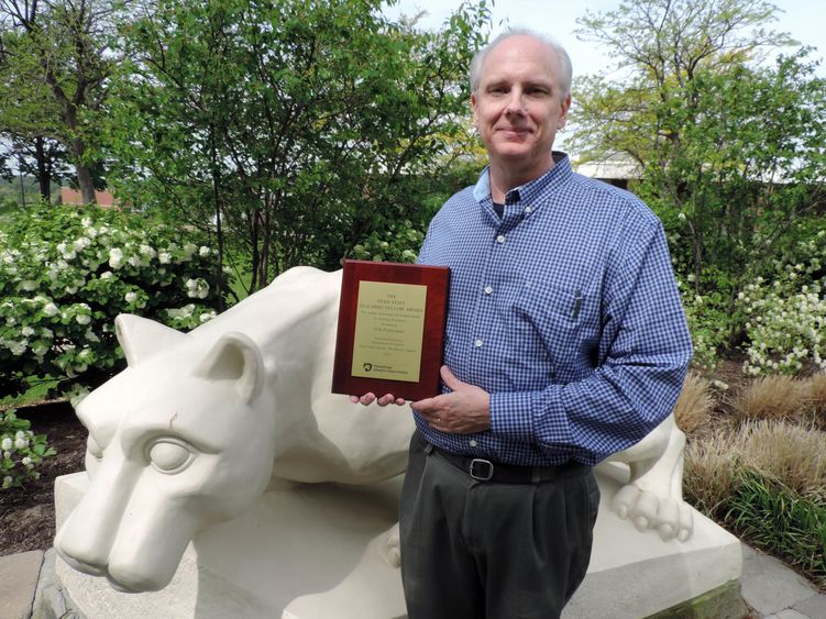 Gib Prettyman with Alumni/Student Award for Excellence in Teaching plaque