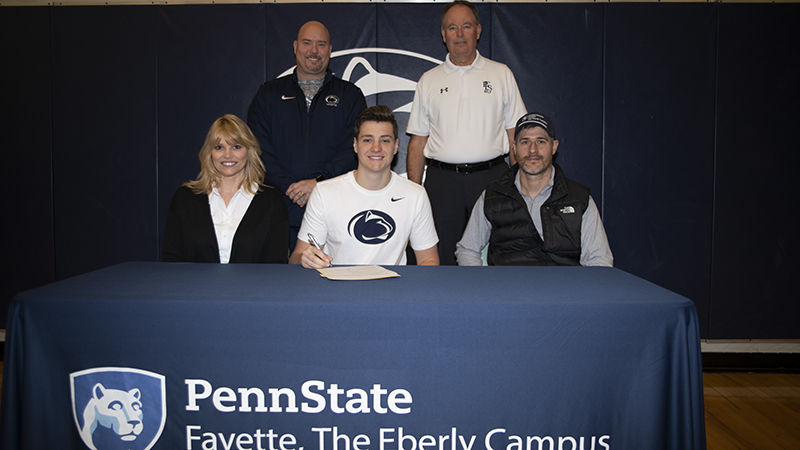 Caption: Lou Zadecky, athletic director; Dave Gumbert, head golf coach; Pamela Greene, Ethan Greene, and James Greene. 