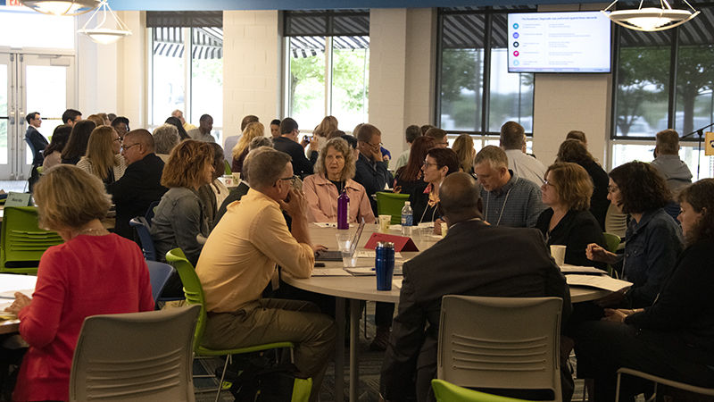 Penn State affiliates gather around tables for a pre-conference session.