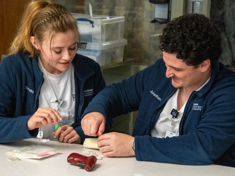 Penn State nursing students engage in a hands-on learning exercise at a simulation lab.