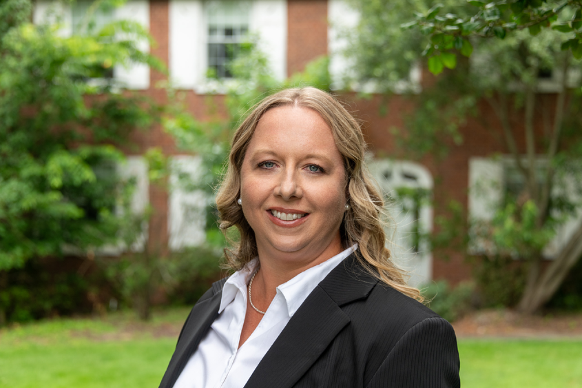 Lindsey-Simon Jones stands in front of the University House at Penn State Fayette, The Eberly Campus.