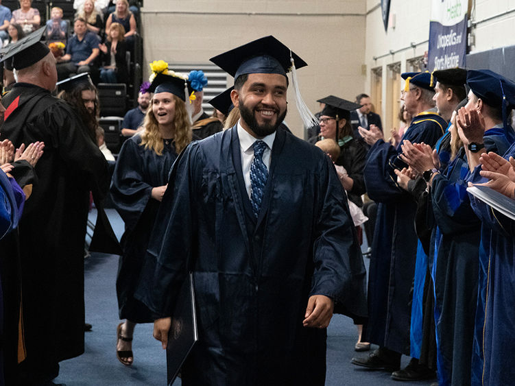 Students being congratulated by faculty during graduation